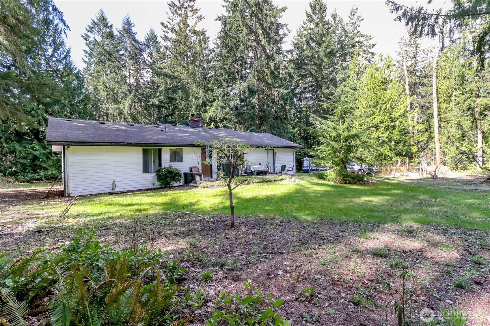 4701 292nd Street East Graham, WA 98338 - Photo 28 of 40 a view of a house with yard and tree s