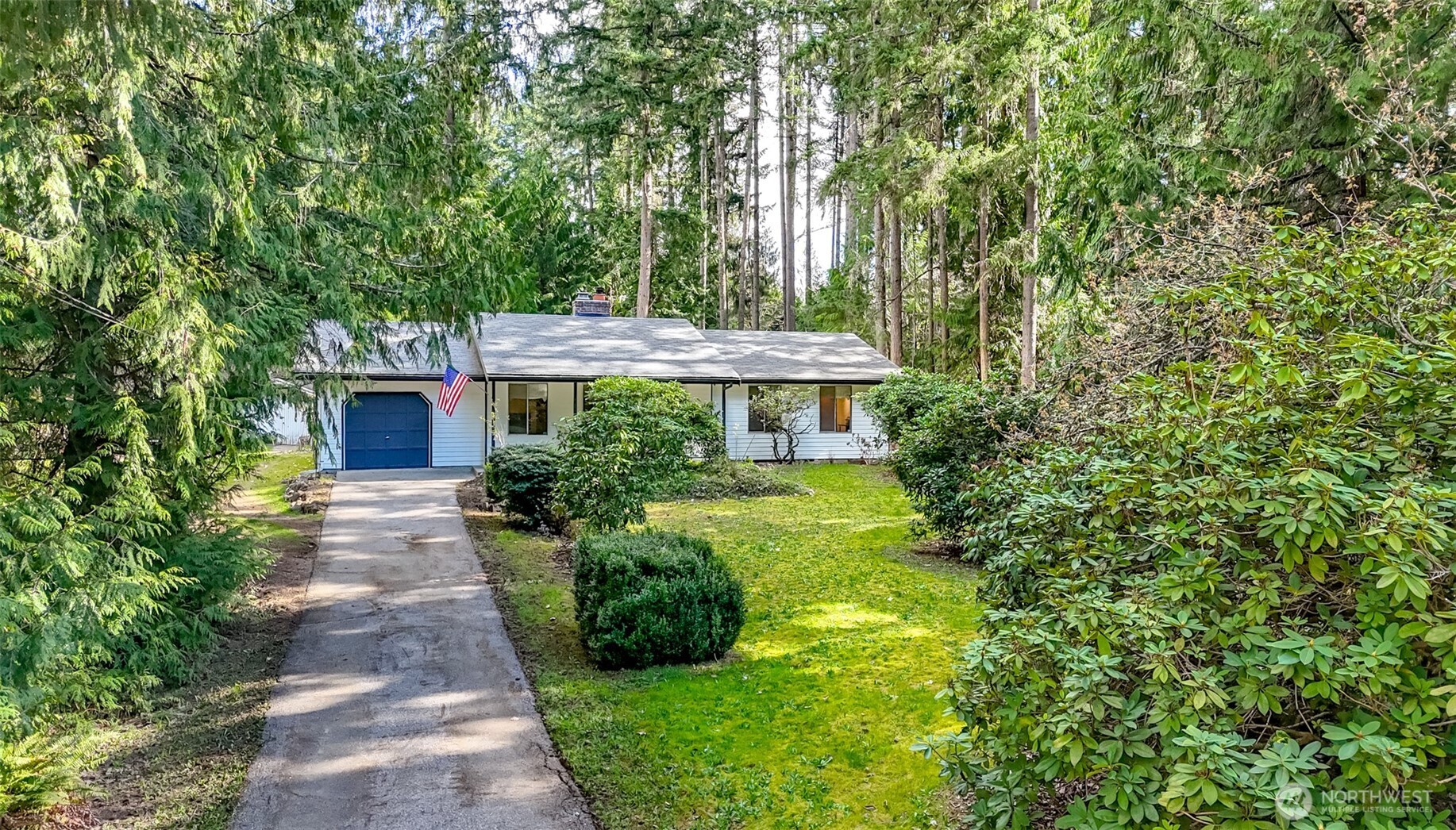 4701 292nd Street East Graham, WA 98338 - Photo 4 of 40 a front view of a house with garden