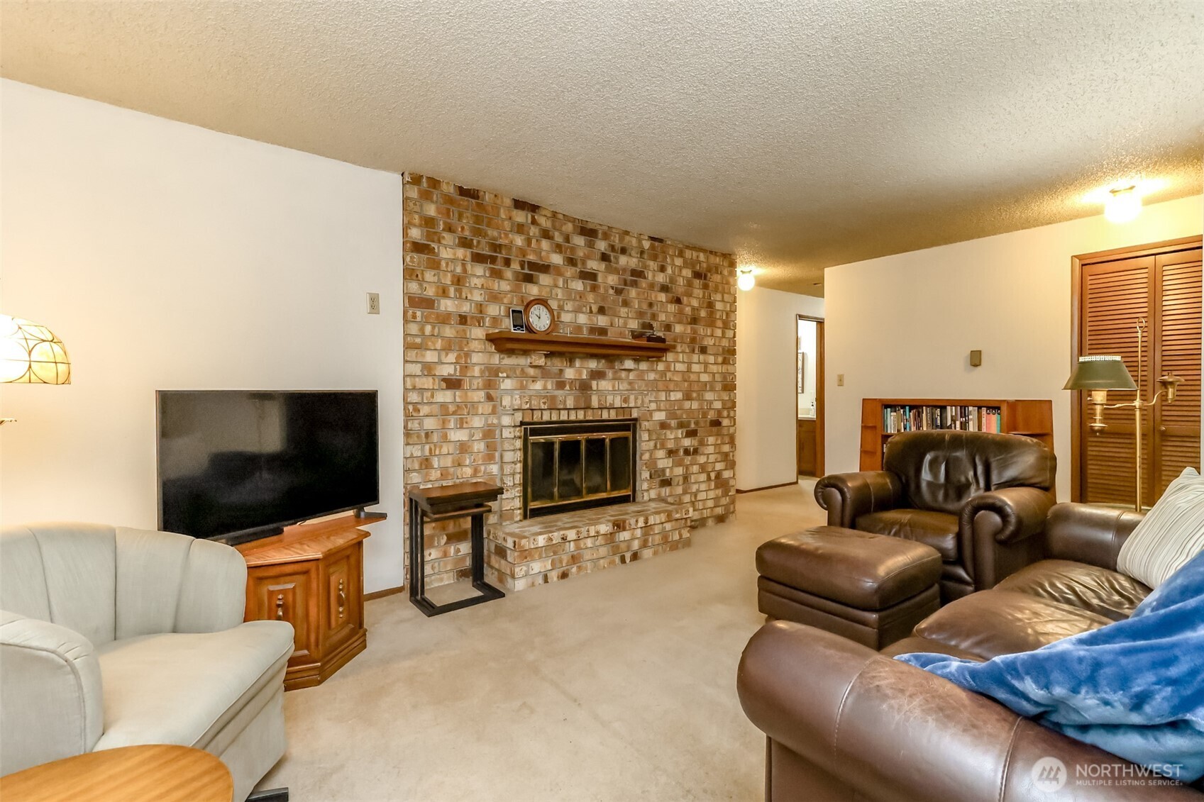 4701 292nd Street East Graham, WA 98338 - Photo 7 of 40 a living room with furniture and a flat screen tv