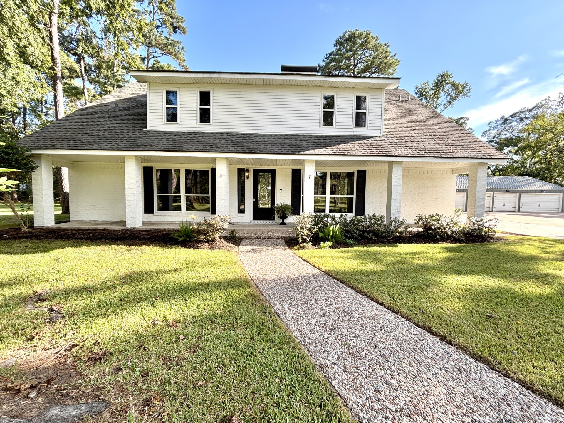 211 Garden West Conroe, TX 77304 - Photo 2 of 35 Here's a closer look at the home with new low-e double pane windows and an inviting front porch.