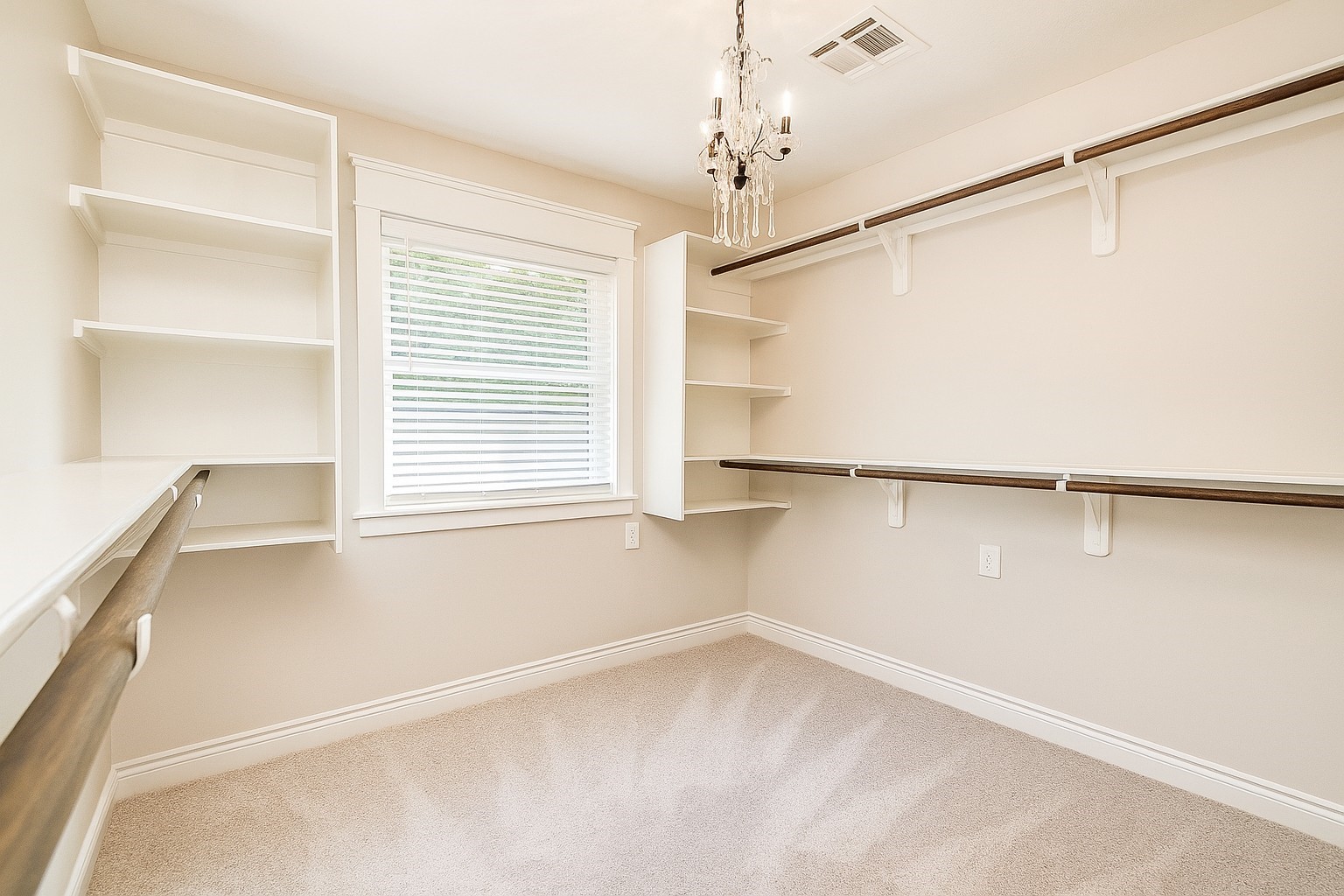 211 Garden West Conroe, TX 77304 - Photo 21 of 35 Plenty of space in this closet, and who can resist a charming little chandelier.
