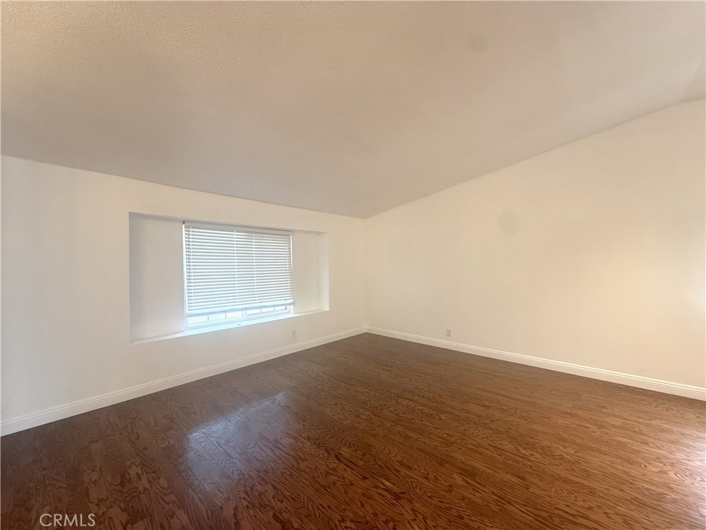 977 Wellington Road San Dimas, CA 91773 - Photo 2 of 20 an empty room with wooden floor and windows