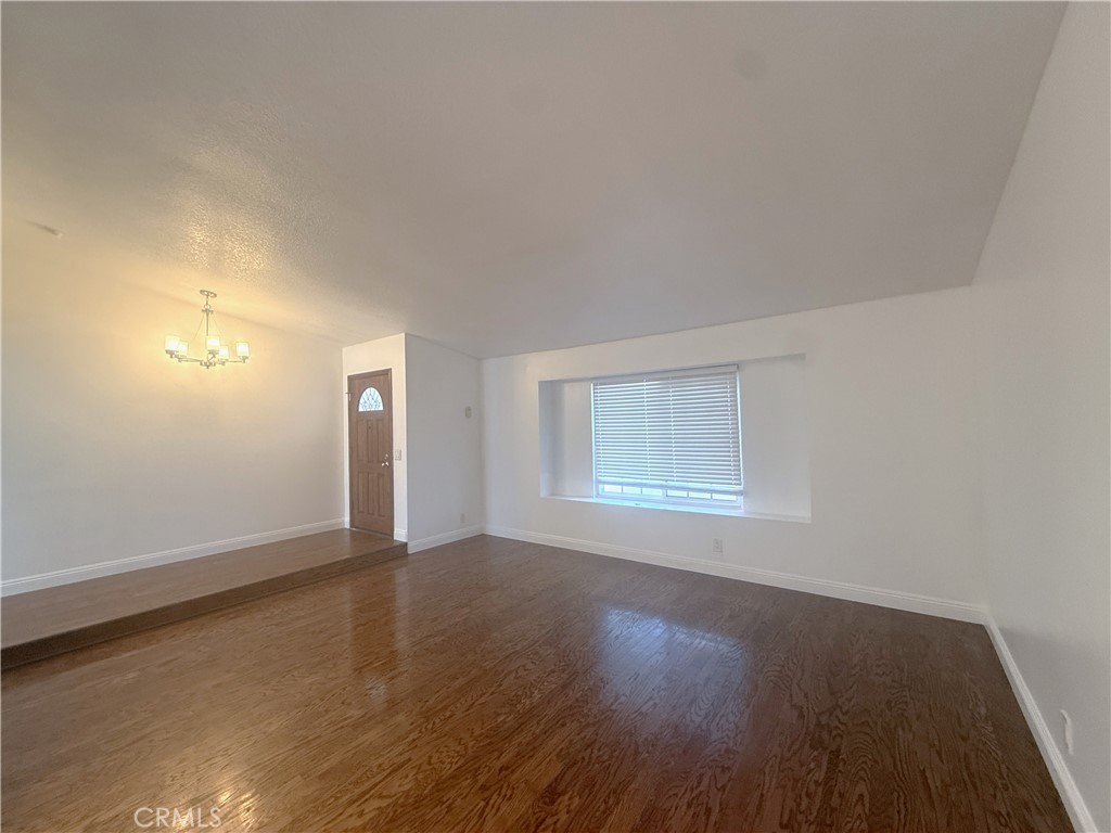 977 Wellington Road San Dimas, CA 91773 - Photo 4 of 20 an empty room with wooden floor and windows