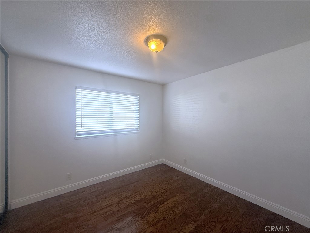 977 Wellington Road San Dimas, CA 91773 - Photo 10 of 20 wooden floor in an empty room with a window