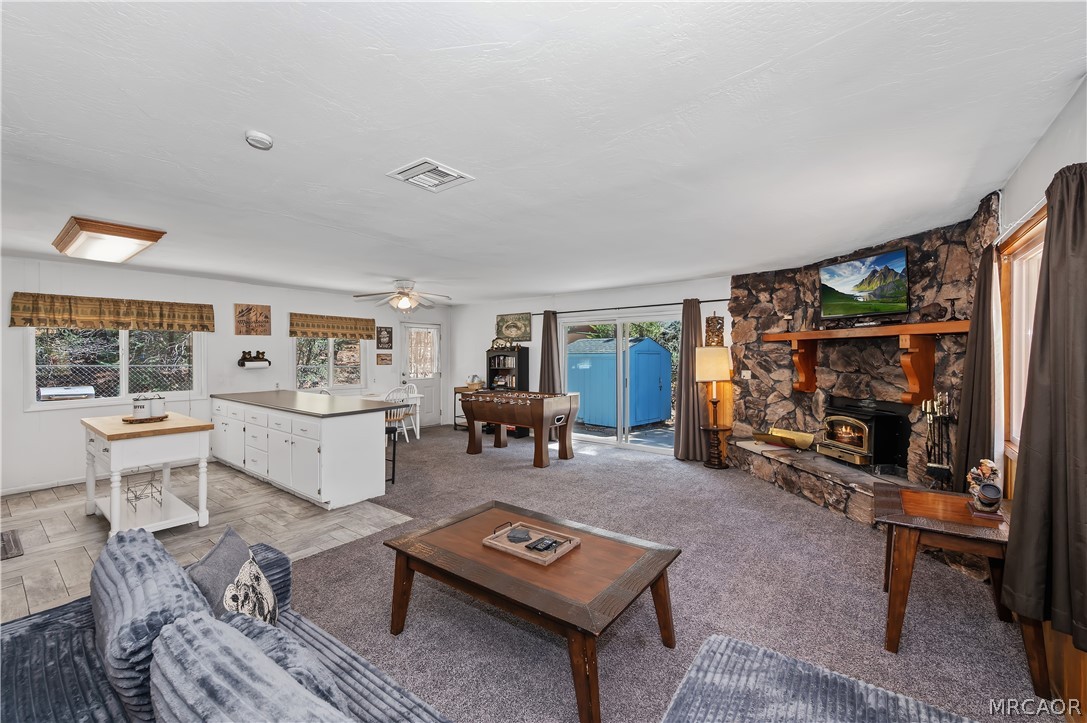 1099 Canyon Road Fawnskin, CA 92333 - Photo 7 of 39 a living room with furniture a window and a table
