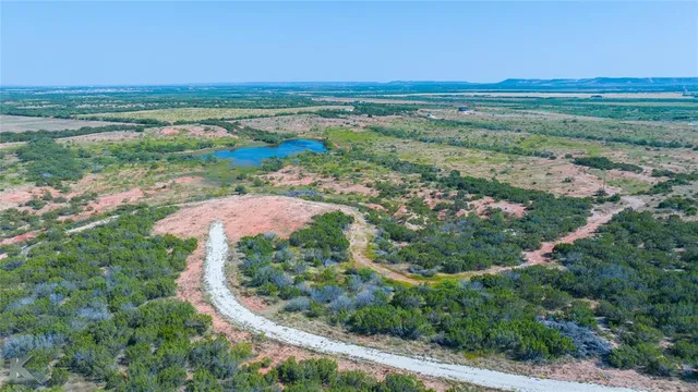 an aerial view of beach and residential houses with outdoor space