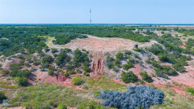 a view of a street with a field
