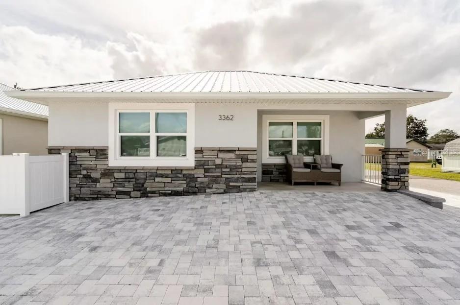 a view of a house with sitting area and furniture
