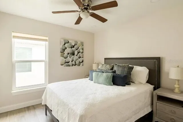 a bedroom with a bed and wooden floor