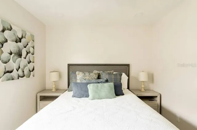 a bedroom with a bed and a lamp