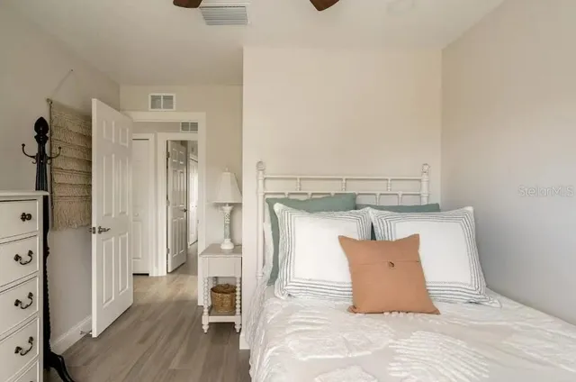 a bedroom with a bed and wooden floor