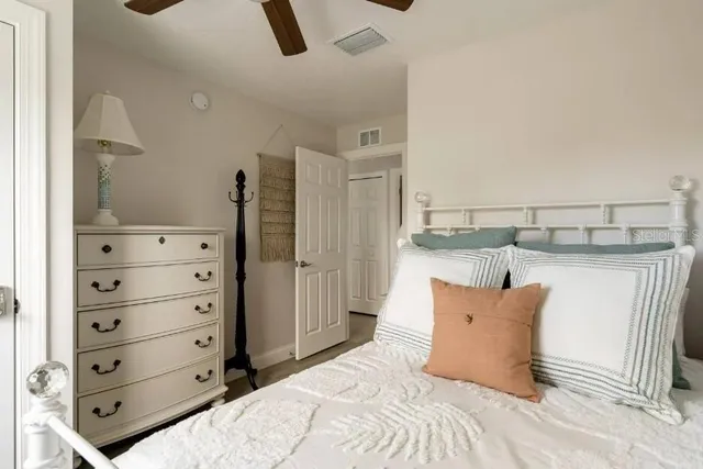 a bedroom with a bed and cabinet