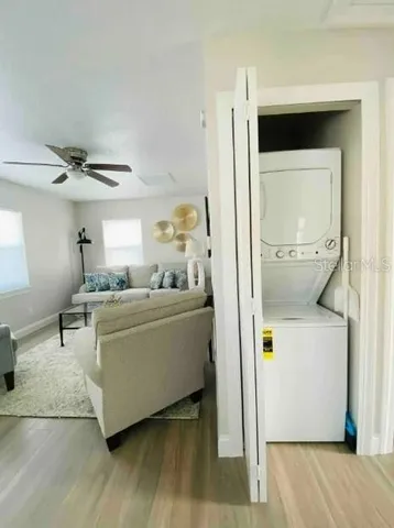 a living room with a couch and a dresser with wooden floor