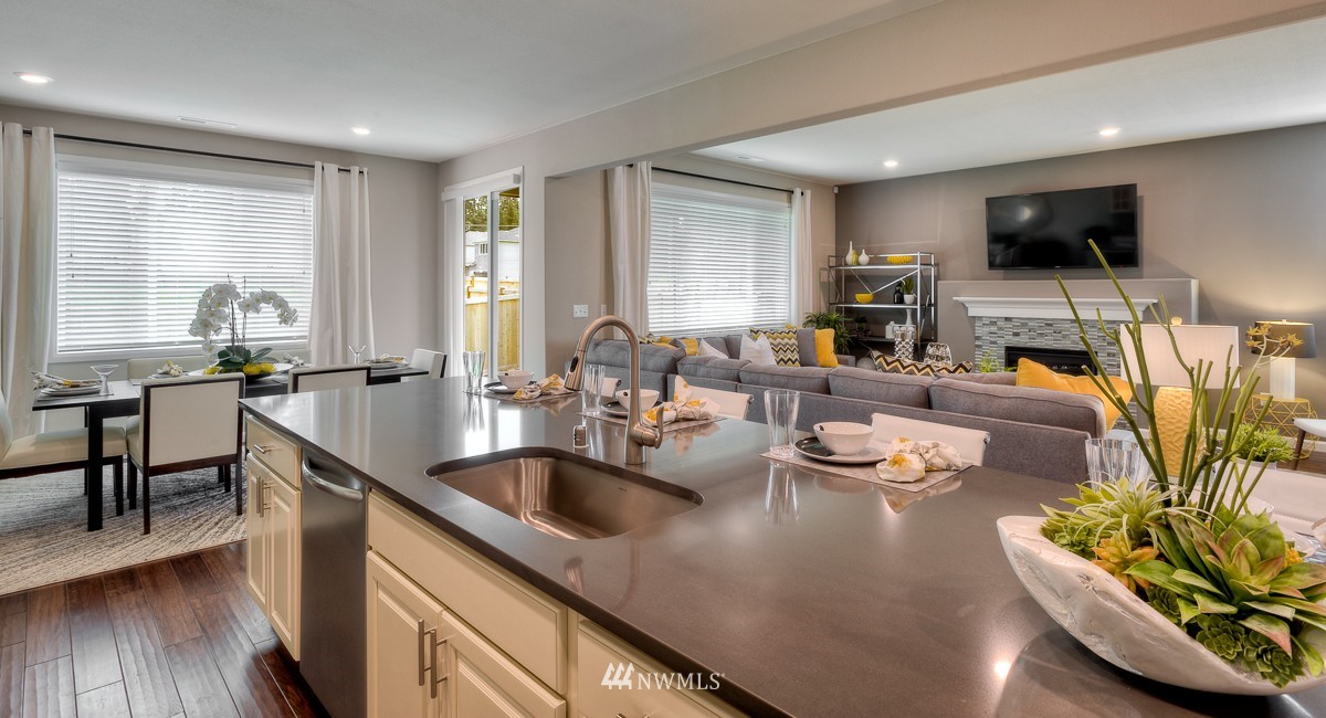 21319 42nd Avenue Southeast, Unit 11 Bothell, WA 98021 - Photo 14 of 25 a kitchen with stainless steel appliances granite countertop a sink a stove and a wooden floors