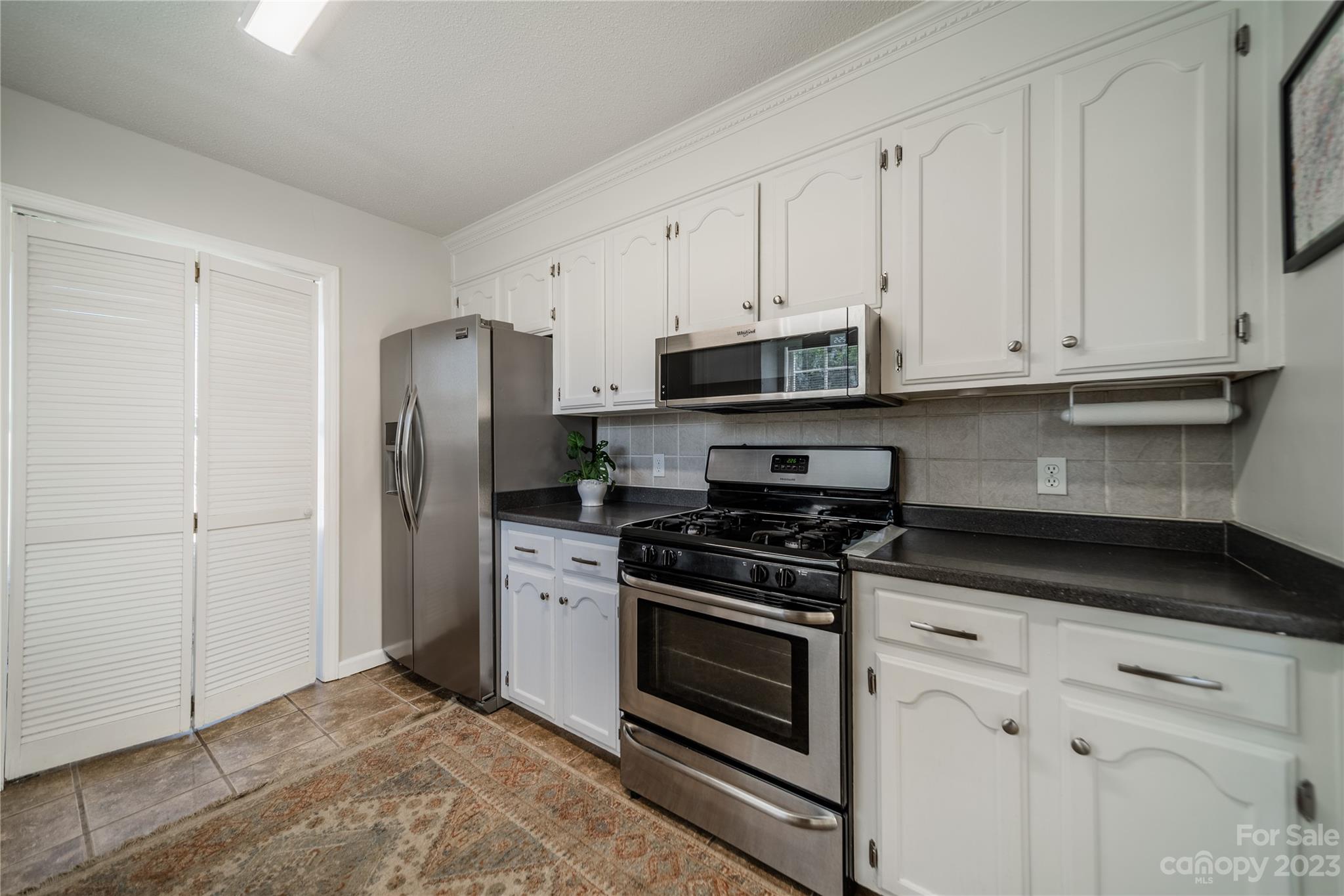 1585 Wimbleton Woods Drive Fort Mill, SC 29708 - Photo 20 of 41 a kitchen with cabinets stainless steel appliances and wooden floor