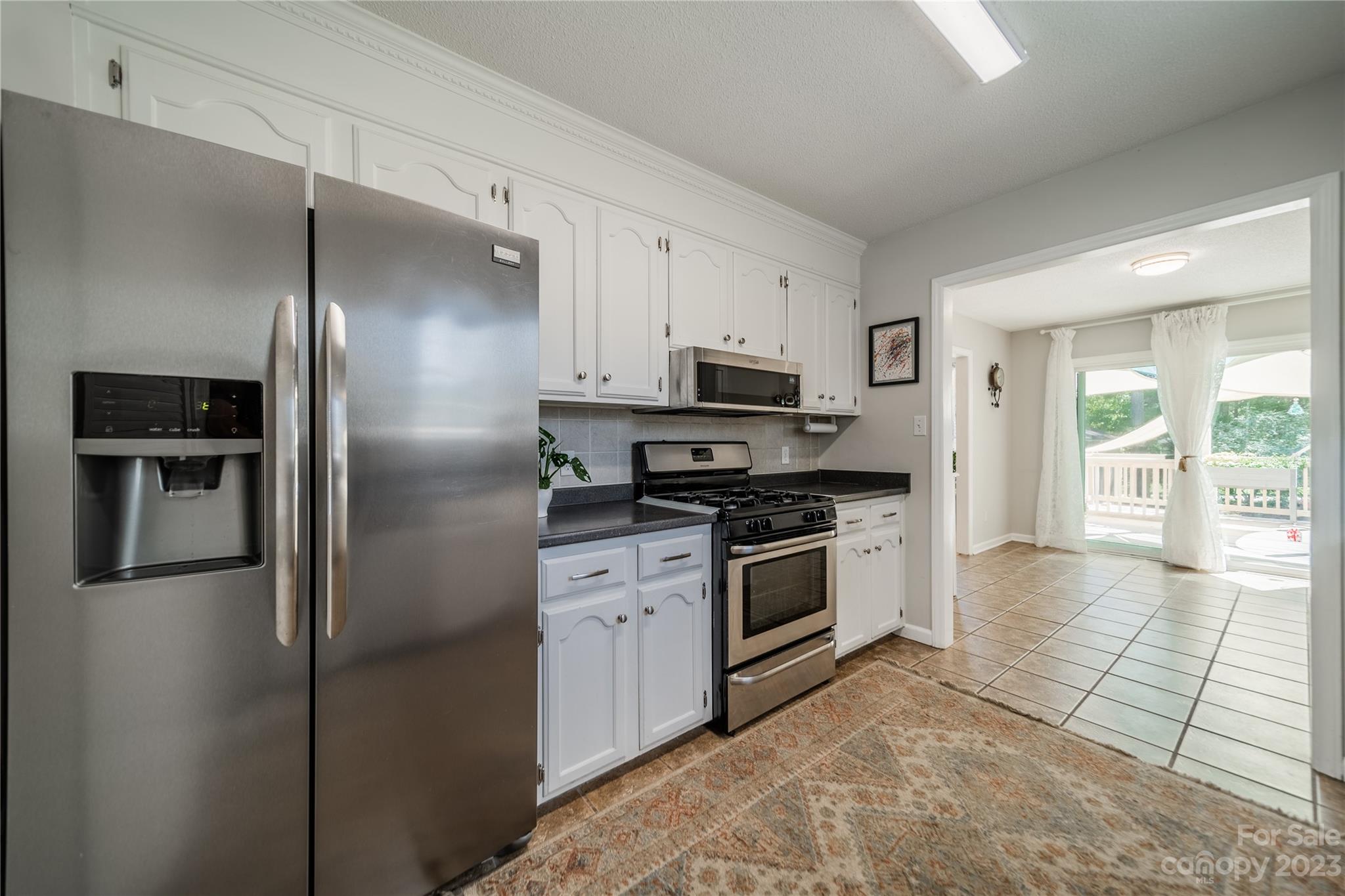1585 Wimbleton Woods Drive Fort Mill, SC 29708 - Photo 22 of 41 a kitchen with stainless steel appliances granite countertop a refrigerator a stove and a sink with large window