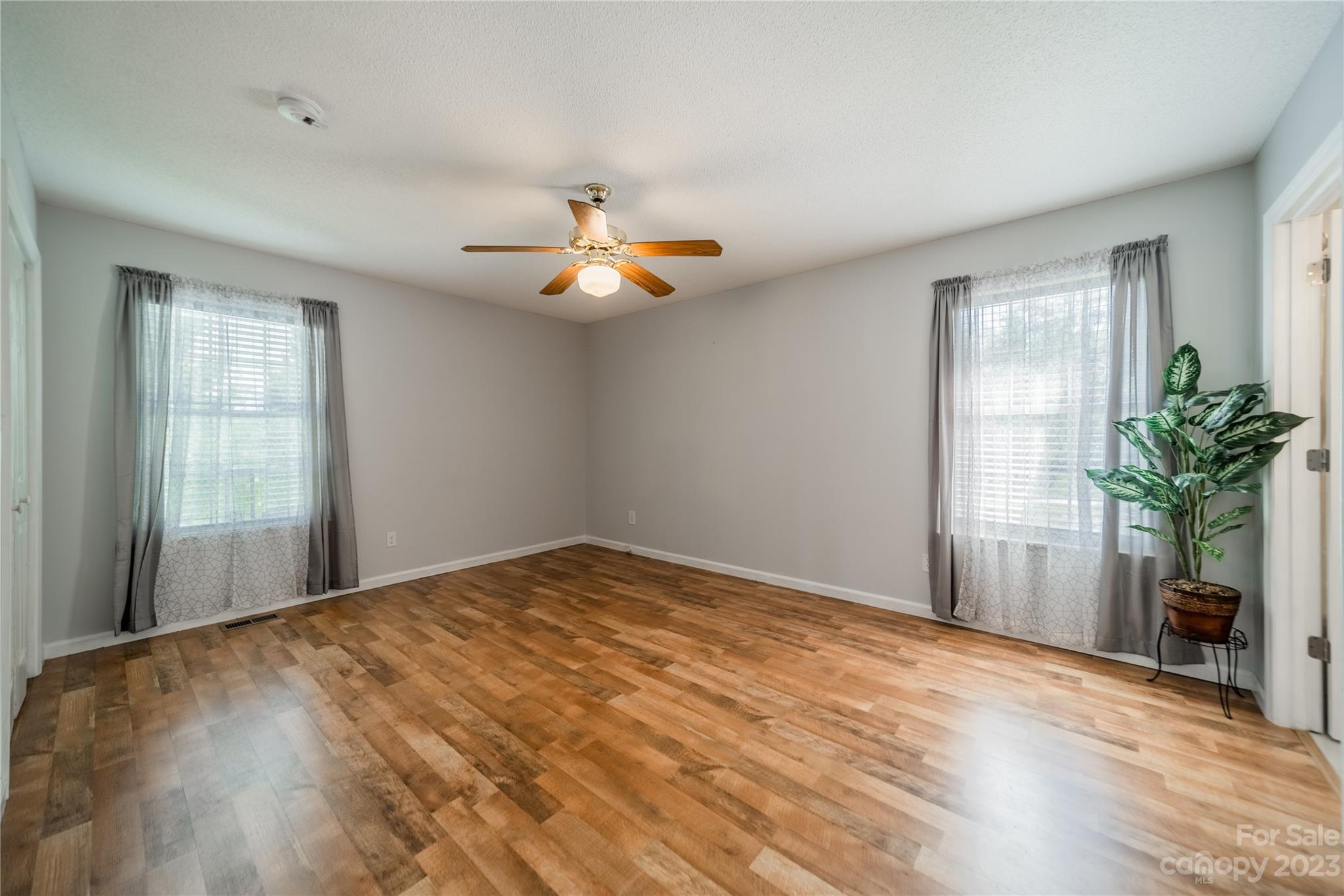 1585 Wimbleton Woods Drive Fort Mill, SC 29708 - Photo 32 of 41 a view of an empty room with a window and wooden floor