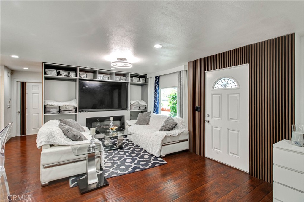 1025 South Riverside Avenue, Unit 26 Rialto, CA 92376 - Photo 8 of 27 a living room with furniture and a flat screen tv