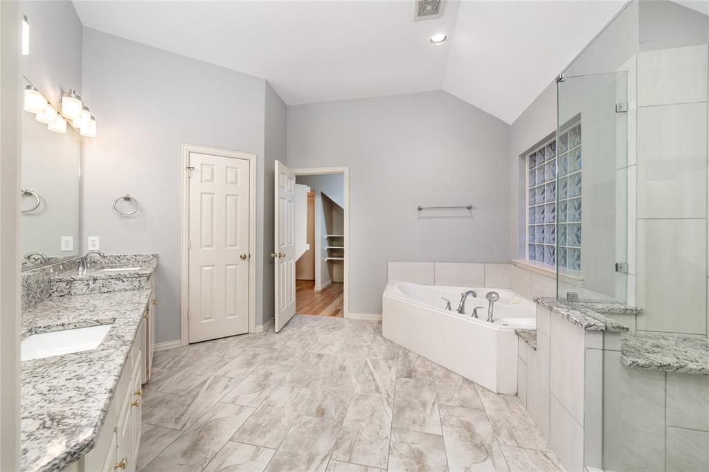 5801 Yeary Road Plano, TX 75093 - Photo 25 of 33 Spacious bathroom featuring a vaulted ceiling and tile flooring