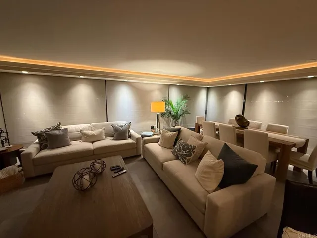 a living room with furniture and a ceiling fan