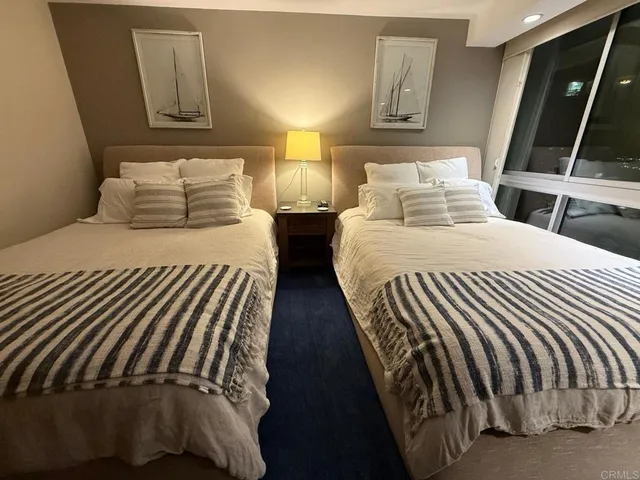 a bedroom with double bed and a window