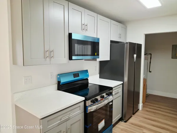 a kitchen with a stove and a refrigerator