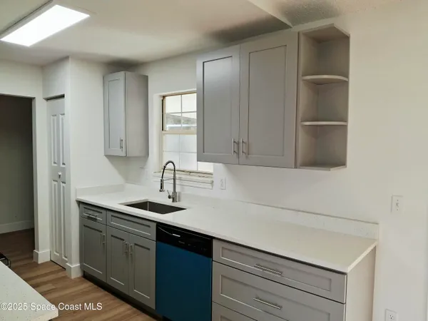 a kitchen with a sink and a refrigerator