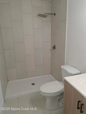 a white toilet sitting next to a bath tub