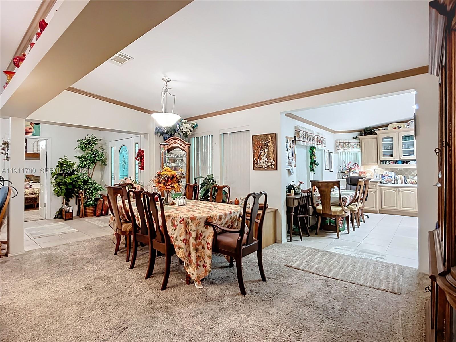 1432 Silver Lake Road LaBelle, FL 33935 - Photo 11 of 39 a view of a dining room with furniture and a potted plant