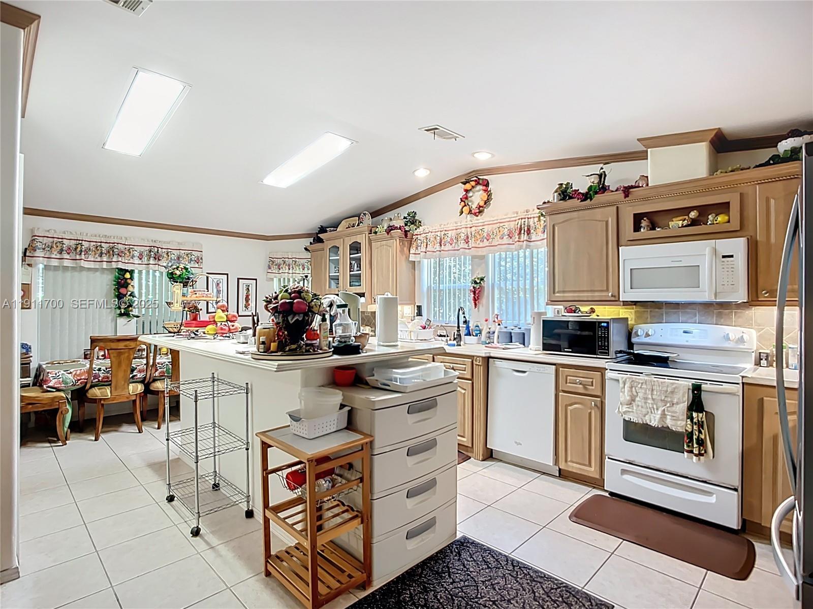 1432 Silver Lake Road LaBelle, FL 33935 - Photo 14 of 39 a kitchen with stainless steel appliances a stove and more cabinets