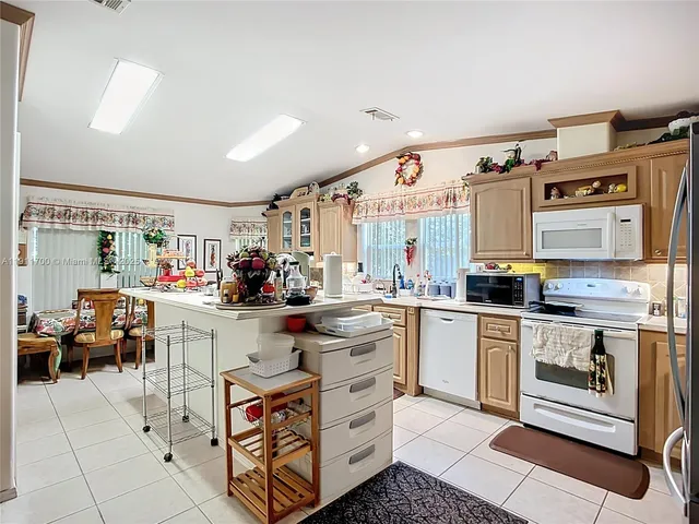a kitchen with stainless steel appliances a stove and more cabinets