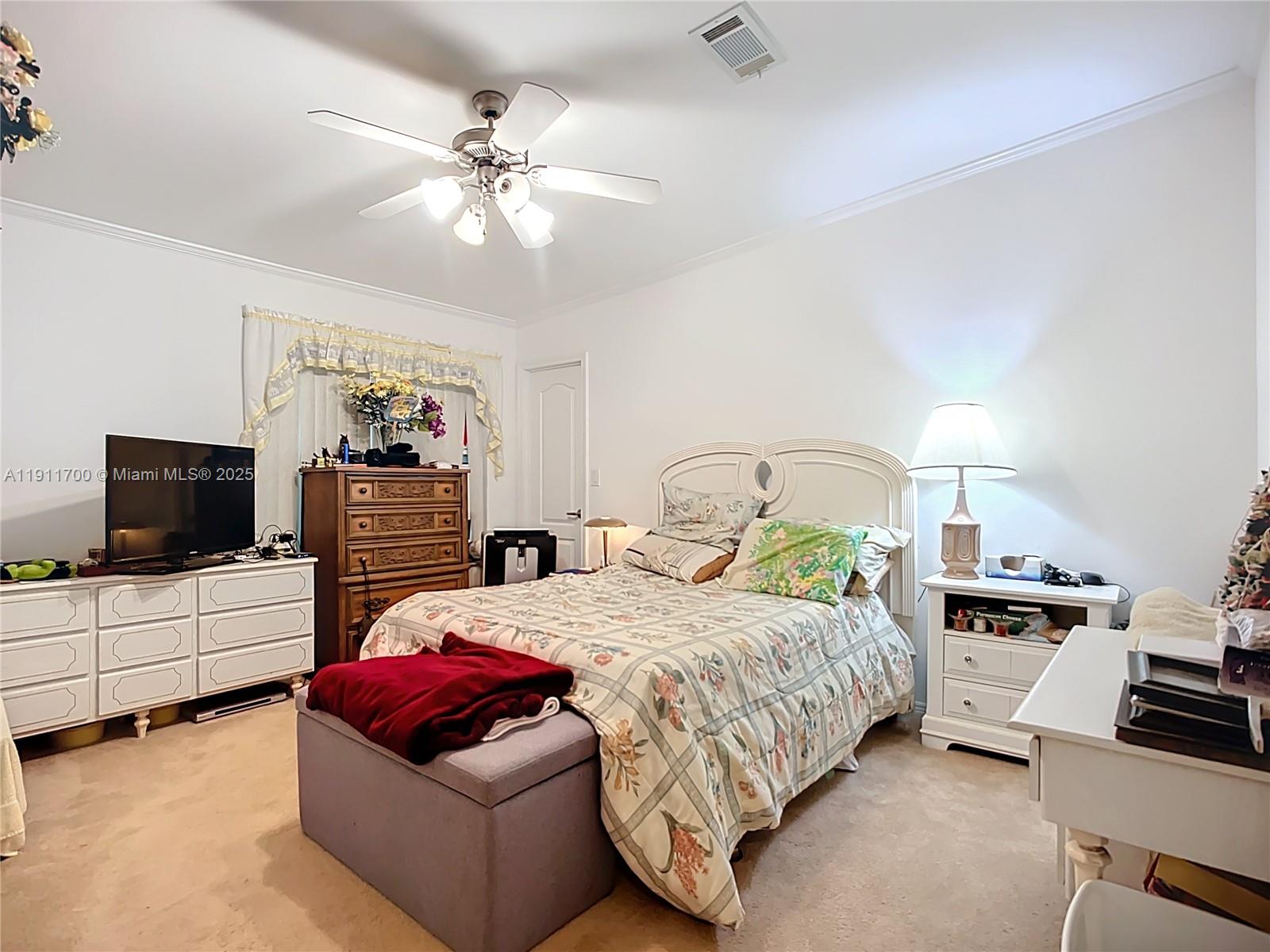 1432 Silver Lake Road LaBelle, FL 33935 - Photo 21 of 39 a bedroom with a bed and a flat screen tv