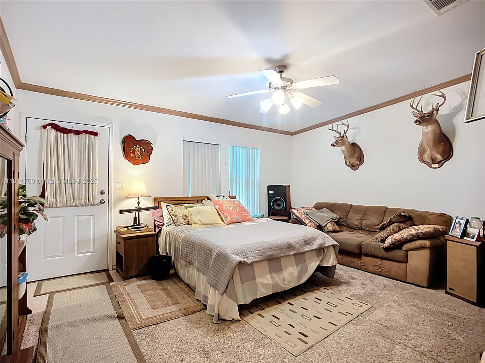 1432 Silver Lake Road LaBelle, FL 33935 - Photo 22 of 39 a bedroom with a bed and ceiling fan