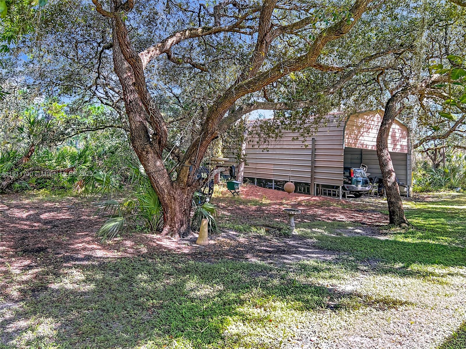 1432 Silver Lake Road LaBelle, FL 33935 - Photo 29 of 39 a backyard of a house with entertaining space