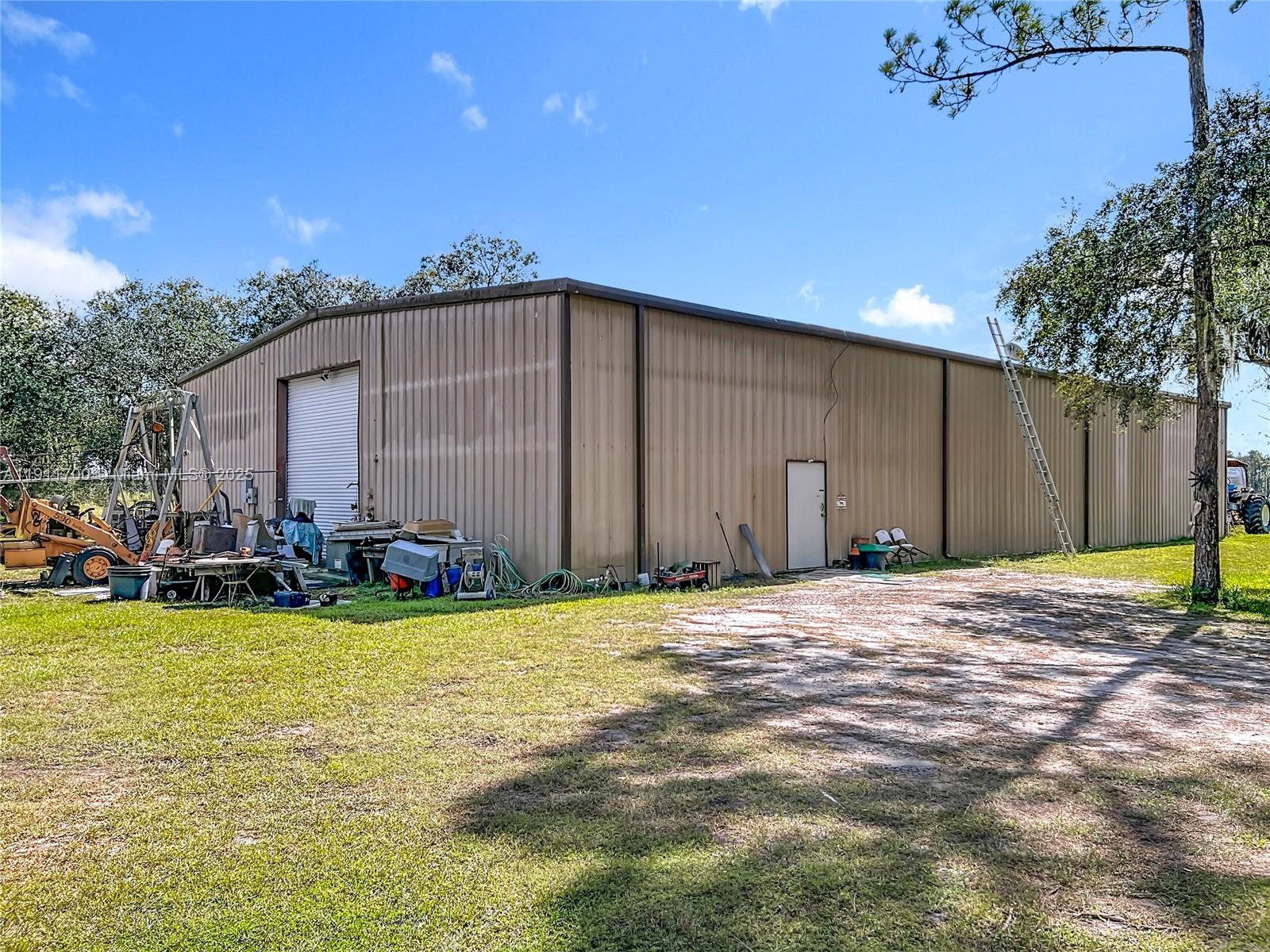 1432 Silver Lake Road LaBelle, FL 33935 - Photo 35 of 39 a view of a house with backyard and sitting area