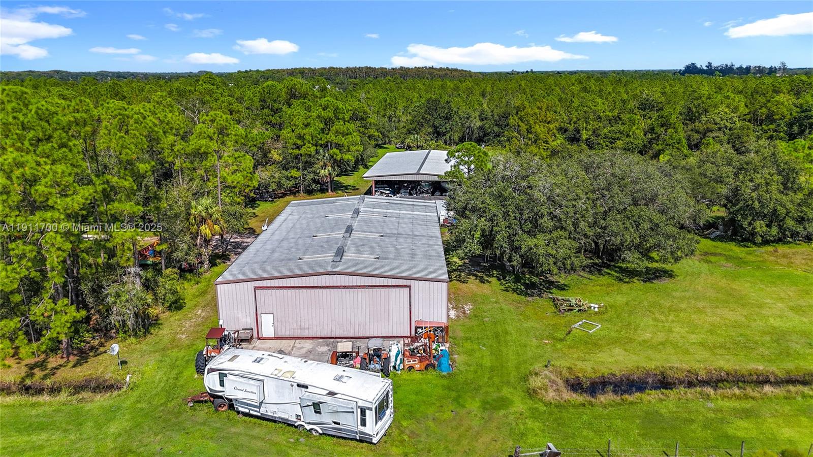 1432 Silver Lake Road LaBelle, FL 33935 - Photo 36 of 39 an aerial view of a house with a garden and swimming pool