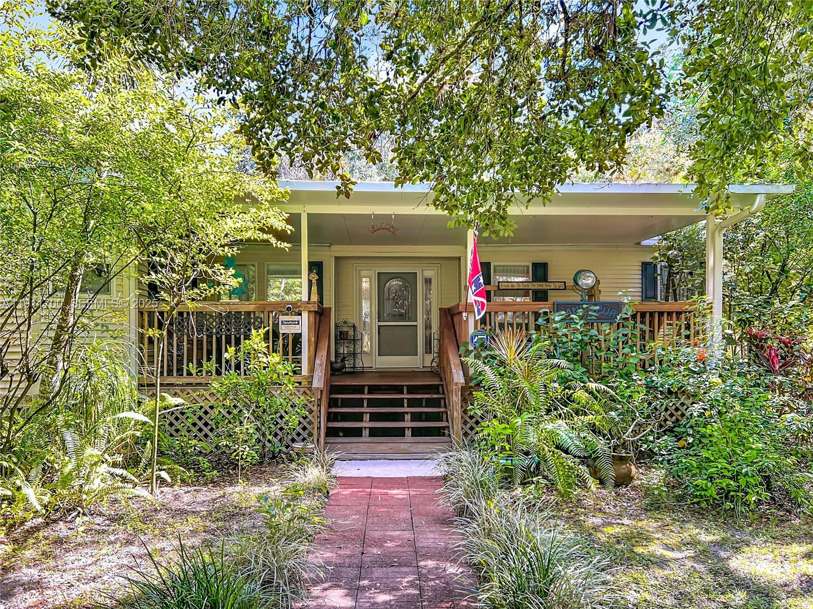 1432 Silver Lake Road LaBelle, FL 33935 - Photo 5 of 39 front view of a house with potted plants