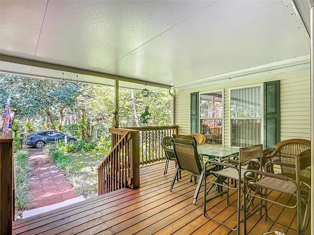 a view of a porch with chairs and backyard