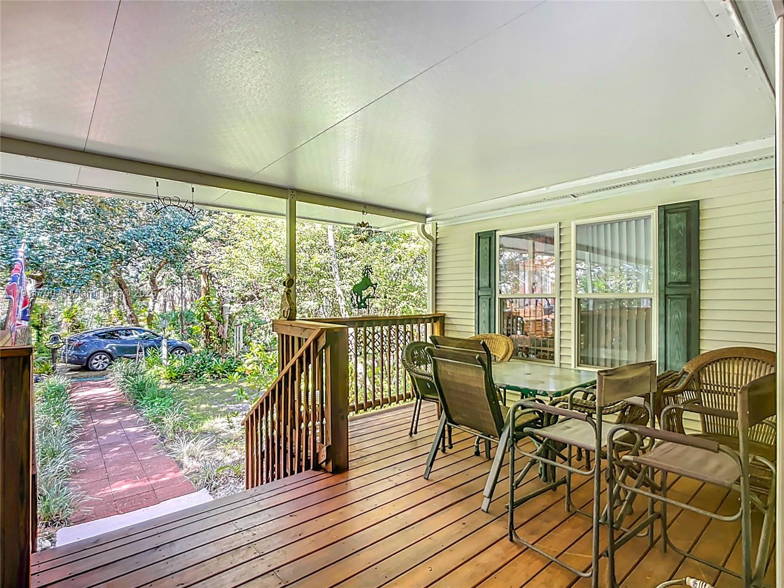 1432 Silver Lake Road LaBelle, FL 33935 - Photo 6 of 39 a view of a porch with chairs and backyard