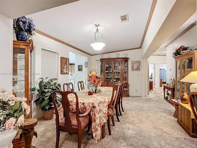 a view of a dining room with furniture and chandelier
