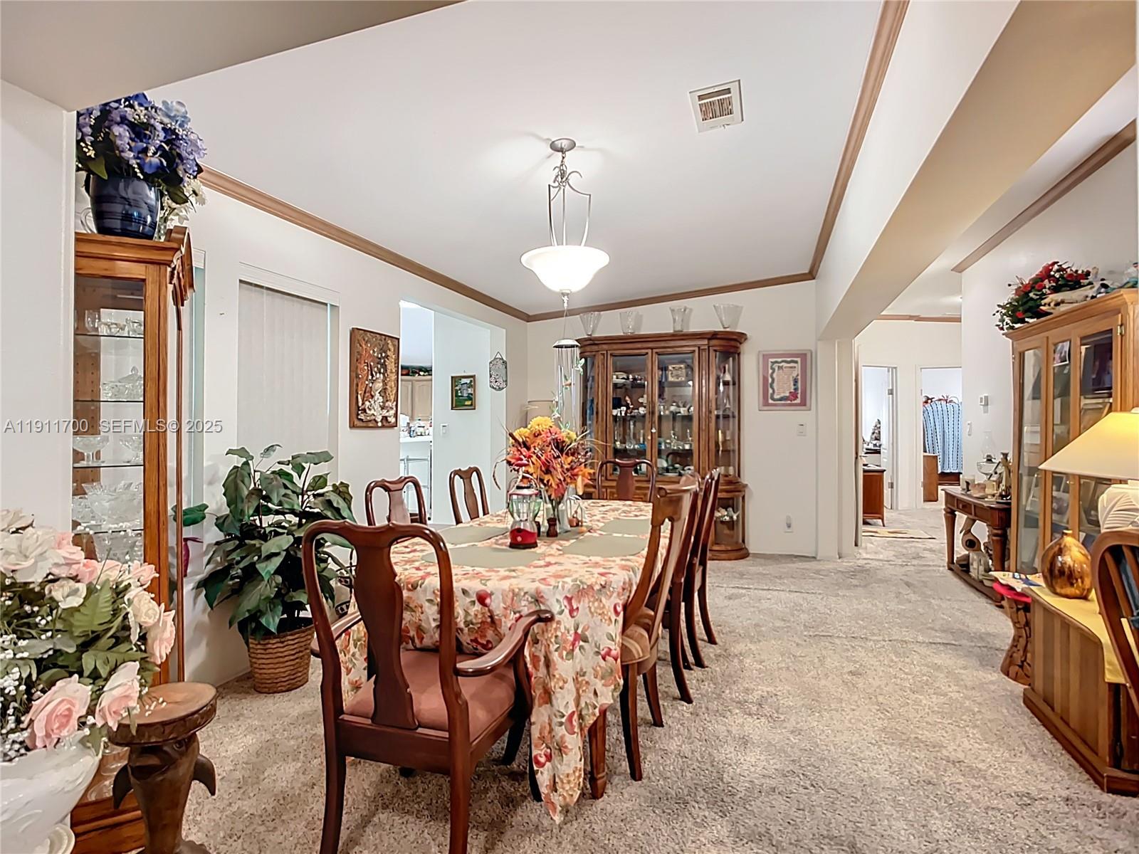 1432 Silver Lake Road LaBelle, FL 33935 - Photo 10 of 39 a view of a dining room with furniture and chandelier