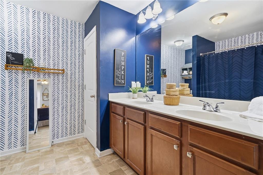 615 Myers Gate Road Ball Ground, GA 30107 - Photo 24 of 43 a bathroom with a sink double vanity and a mirror