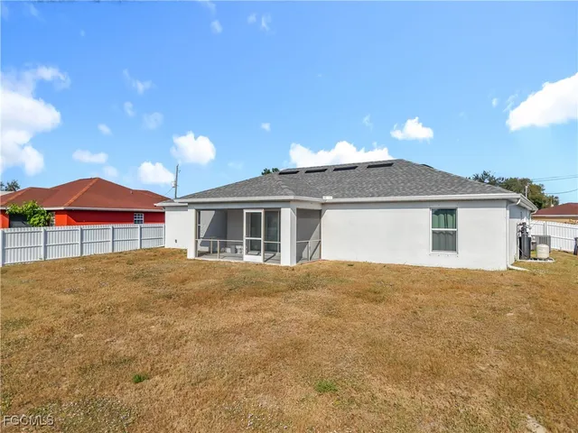 an aerial view of residential houses with outdoor space and ocean