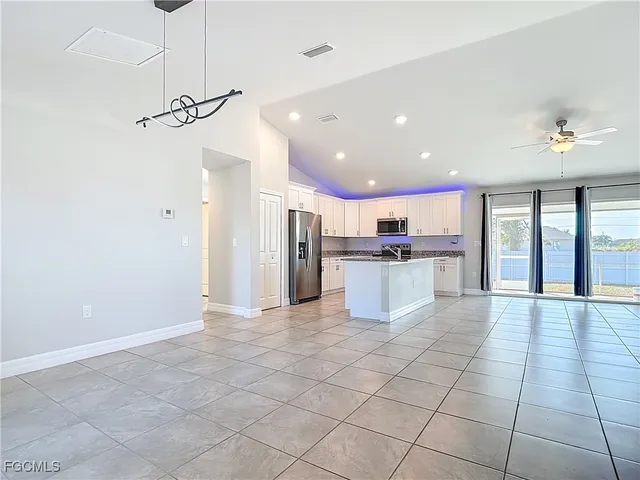a view of a kitchen with a sink and cabinets