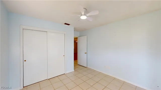 a view of a chairs and table in patio with a small yard