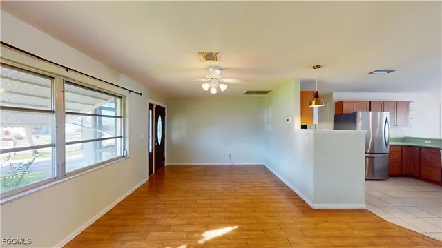 a view of a kitchen with a dishwasher and wooden floor