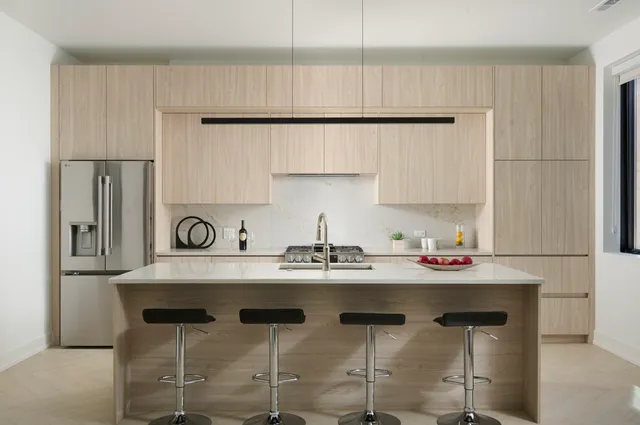 a kitchen with stainless steel appliances granite countertop a sink and a refrigerator