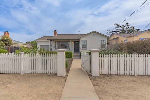 a front view of a house with a fence