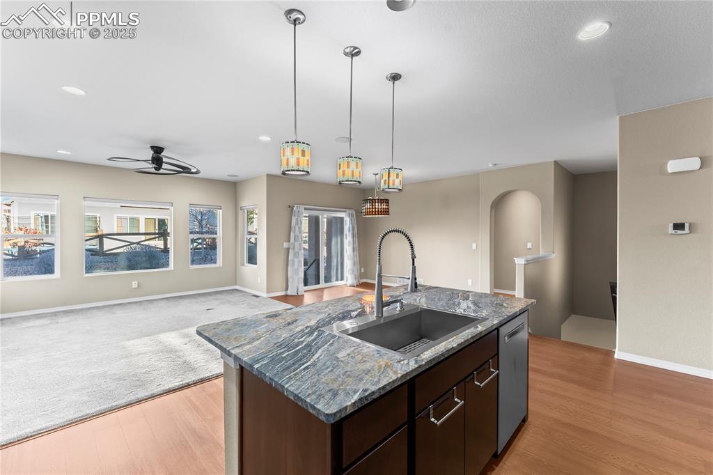6208 Ashmore Road Colorado Springs, CO 80927 - Photo 14 of 50 Kitchen featuring dark brown cabinetry, open floor plan, recessed lighting, hanging light fixtures, and ceiling fan