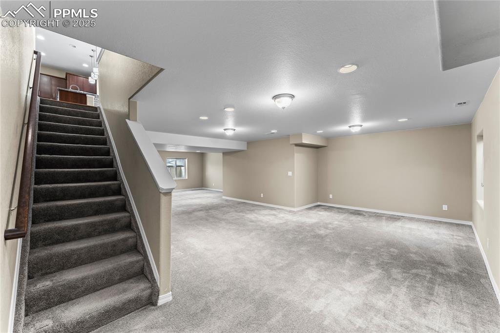 6208 Ashmore Road Colorado Springs, CO 80927 - Photo 29 of 50 Basement with carpet, stairway, and recessed lighting